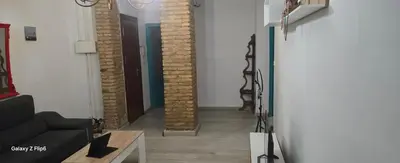 a hallway with brick columns in a living room at Relax y bienestar in Valencia