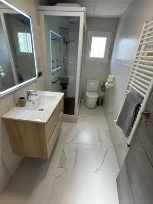 a bathroom with a sink and a toilet and a mirror at Chalet encanto in Chiva