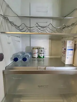 an open refrigerator with bottles of water and milk at Chalet encanto in Chiva