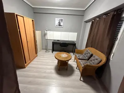a living room with a chair and a table at Chalet encanto in Chiva