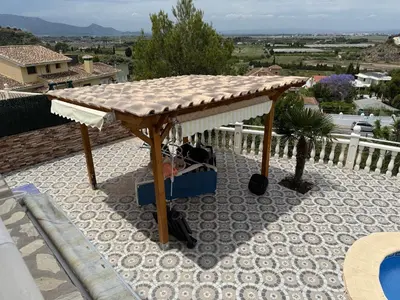 a wooden umbrella on top of a patio at Villa avec superbe vue in Cullera