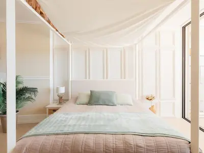 a white bedroom with a bed with a canopy at Marsalada 2 - Apartment with sea view in Playa de Mar