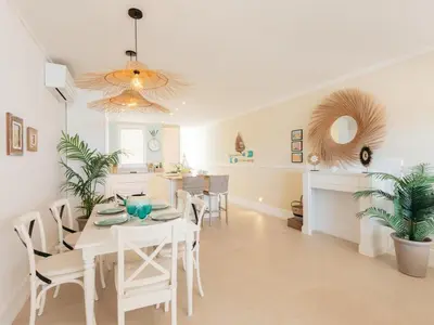 a dining room with a white table and chairs at Marsalada 2 - Apartment with sea view in Playa de Mar