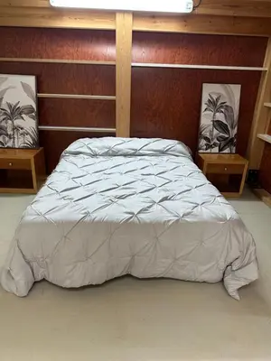 a bedroom with a large bed with a wooden headboard at Habitaciones Espacio in Corbera de Alcira