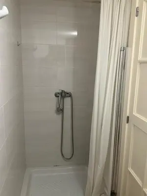 a bathroom with a shower with a shower curtain at Habitaciones Espacio in Corbera de Alcira
