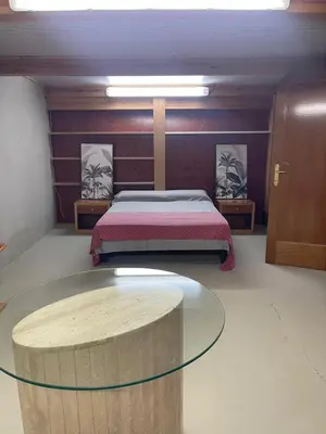 a bedroom with a bed and a glass table at Habitaciones Espacio in Corbera de Alcira