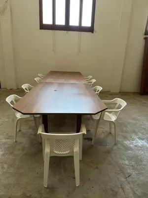 a wooden table and chairs in a room at Habitaciones Espacio in Corbera de Alcira