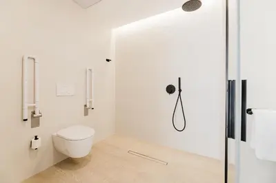 a white bathroom with a toilet and a glass door at Fantástico loft en Valencia in Valencia