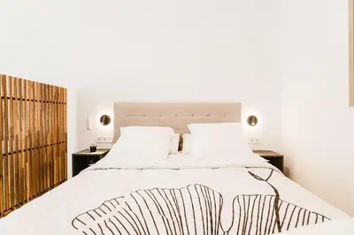 a bedroom with a large bed with white sheets at Fantástico loft en Valencia in Valencia