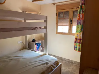 a bedroom with a bunk bed and a window at Casa Altura in Altura