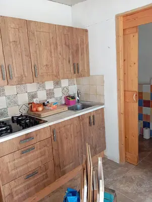 a kitchen with wooden cabinets and a sink at Casa Altura in Altura