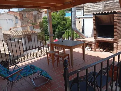 a patio with a table and chairs on a balcony at Casa Altura in Altura