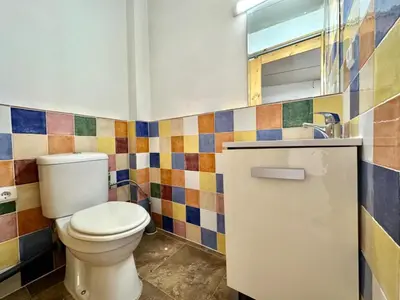 a bathroom with a toilet and colorful tiles at Casa Altura in Altura