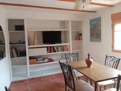 a dining room with a table and a tv at Casa Altura in Altura