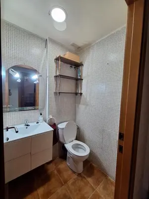 a bathroom with a toilet and a sink and a mirror at Townhouse with pool next to the City of Arts in Valencia
