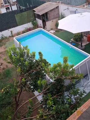 an overhead view of a swimming pool with an umbrella at Townhouse with pool next to the City of Arts in Valencia