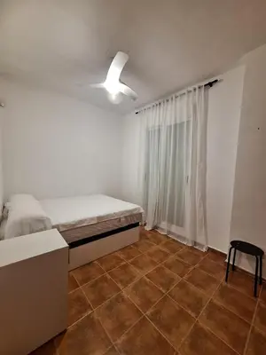 a bedroom with a bed and a ceiling fan at Townhouse with pool next to the City of Arts in Valencia
