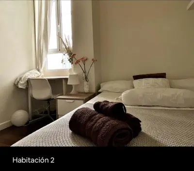 a bedroom with two beds and a window at Welcome to your Home in Valencia