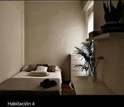 a small room with a bed and a table at Welcome to your Home in Valencia