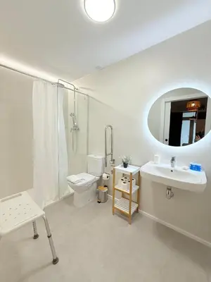 a bathroom with a sink and a toilet and a mirror at Travel Habitat Oceanografic Suites in Valencia