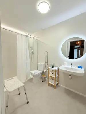 a white bathroom with a sink and a toilet at Travel Habitat Oceanografic Suites in Valencia