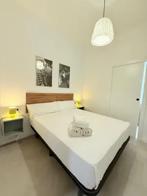 a bedroom with a large white bed in a room at Travel Habitat Oceanografic Suites in Valencia