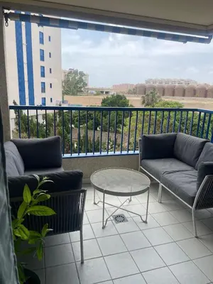 a balcony with couches and a table and a view at Patacona beach apartment in Valencia