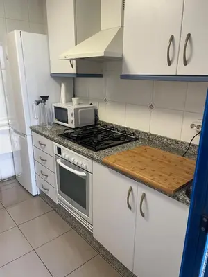 a kitchen with a stove and a microwave at Patacona beach apartment in Valencia