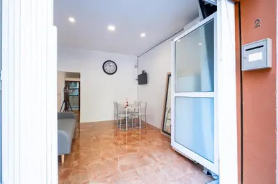 a living room with a clock on the wall at Loft Economico Cerca del Centro 1 Domitorio y Sofa cama 4pax AC in Valencia