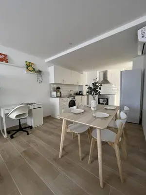 a kitchen and dining room with a table and chairs at More than a lovely flat in Godella