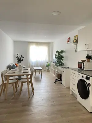 a kitchen and dining room with a table and a table and chairs at More than a lovely flat in Godella