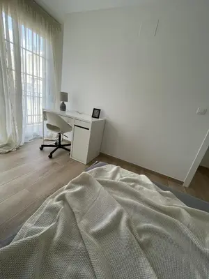 a white bedroom with a desk and a bed at More than a lovely flat in Godella