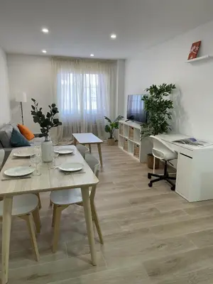 a living room with a table and a couch at More than a lovely flat in Godella