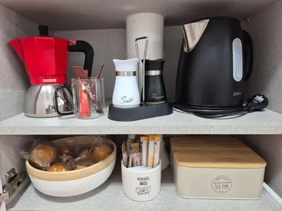 a shelf with a coffee maker and other kitchen items at Beach and City Valencia in Valencia