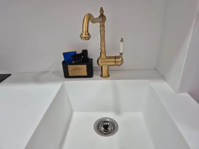 a sink with a brass faucet in a bathroom at Beach and City Valencia in Valencia
