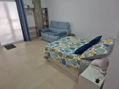 a bedroom with a bed and a chair at Beach and City Valencia in Valencia