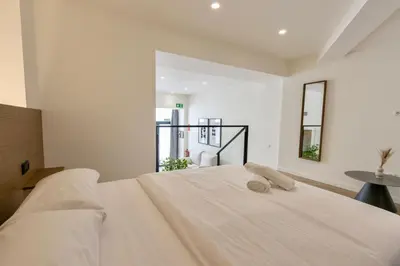 a bedroom with a large white bed with a window at Boutique Room - One Tower in Valencia