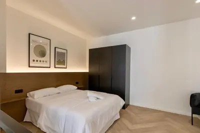 a bedroom with a white bed and a black cabinet at Boutique Room - One Tower in Valencia