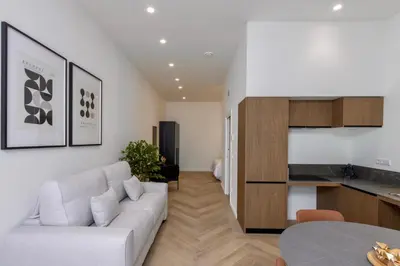 a living room with a white couch and a table at Boutique Room - One Tower in Valencia