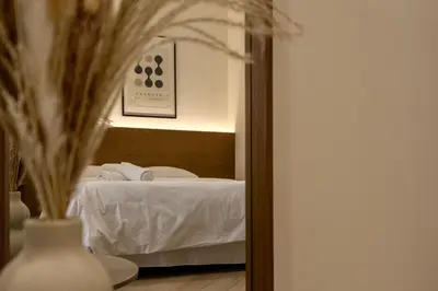 a reflection of a bedroom with a bed in a mirror at Boutique Room - One Tower in Valencia