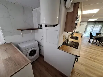 a kitchen with a refrigerator and a washing machine at Piso Burjassot - Valencia in Burjasot