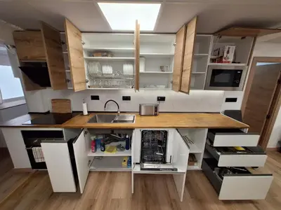 a kitchen with white cabinets and a counter top at Piso Burjassot - Valencia in Burjasot