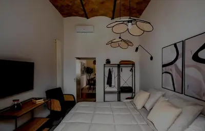 a bedroom with a bed and a tv and a couch at Apartamento Aleyda in Valencia