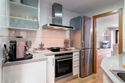 a kitchen with a stove and a refrigerator at Beach apartment in Valencia