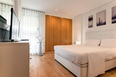 a bedroom with a bed and a flat screen tv at Beach apartment in Valencia