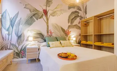 a bedroom with a bed with a plate of fruit on it at Naturaloft in Valencia