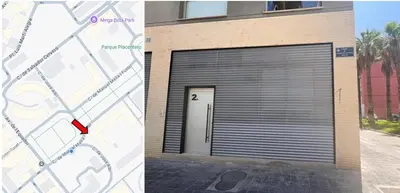 a building with a garage door with a red arrow at Naturaloft in Valencia