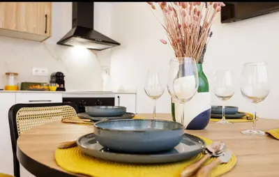 a wooden table with plates and wine glasses on it at Naturaloft in Valencia