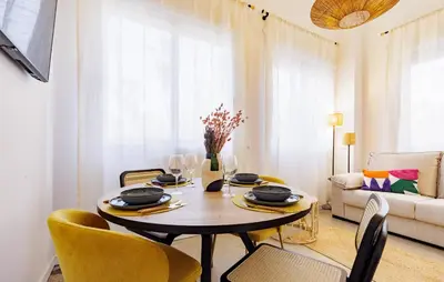 a dining room with a table and chairs and a couch at Naturaloft in Valencia