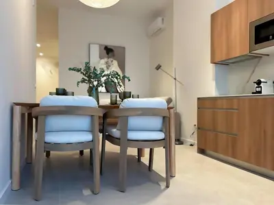a dining room with a table and two chairs at Pivote Flats-Puerto B in Valencia